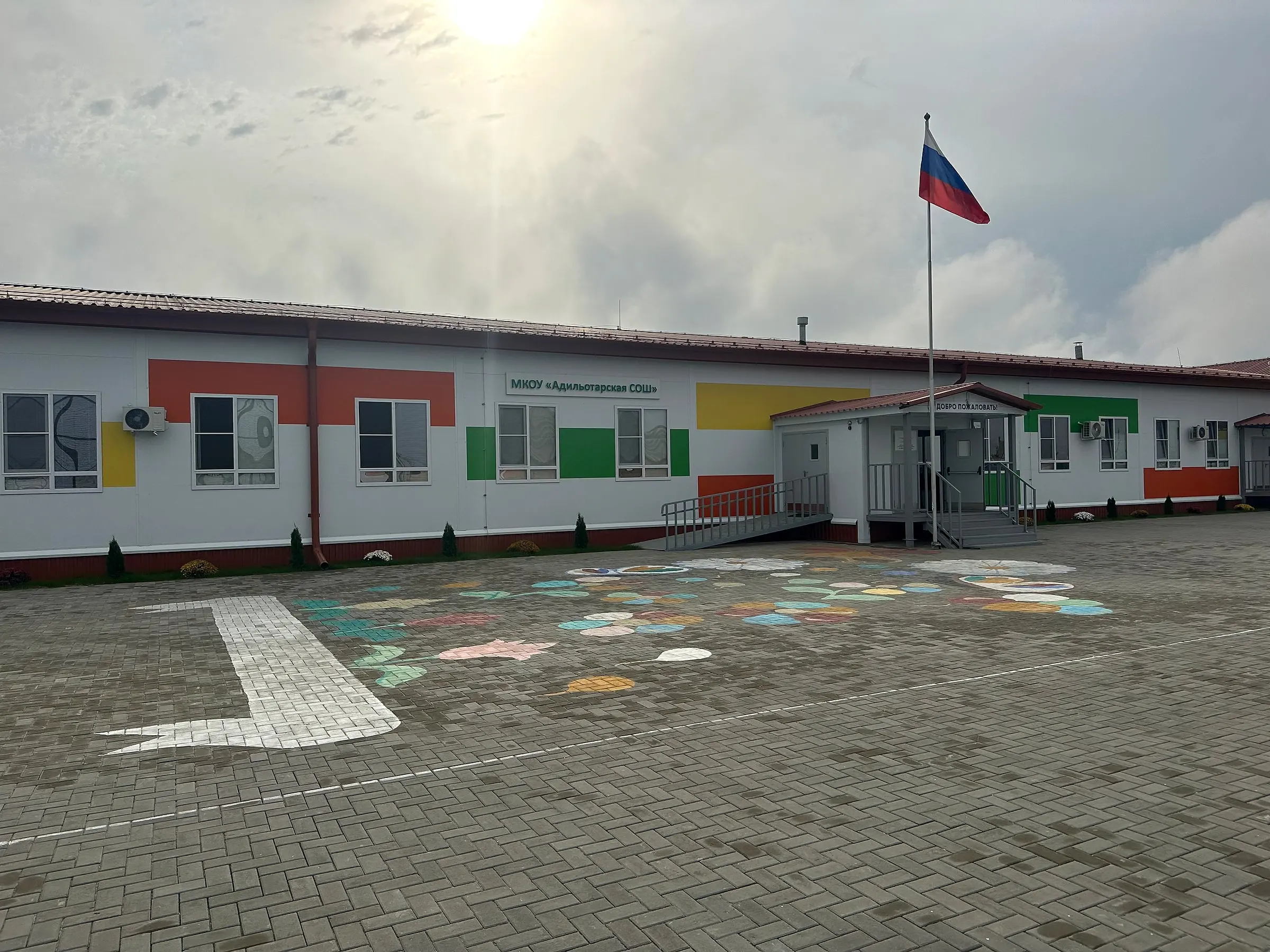 Главный вход и школьный двор с флагом России