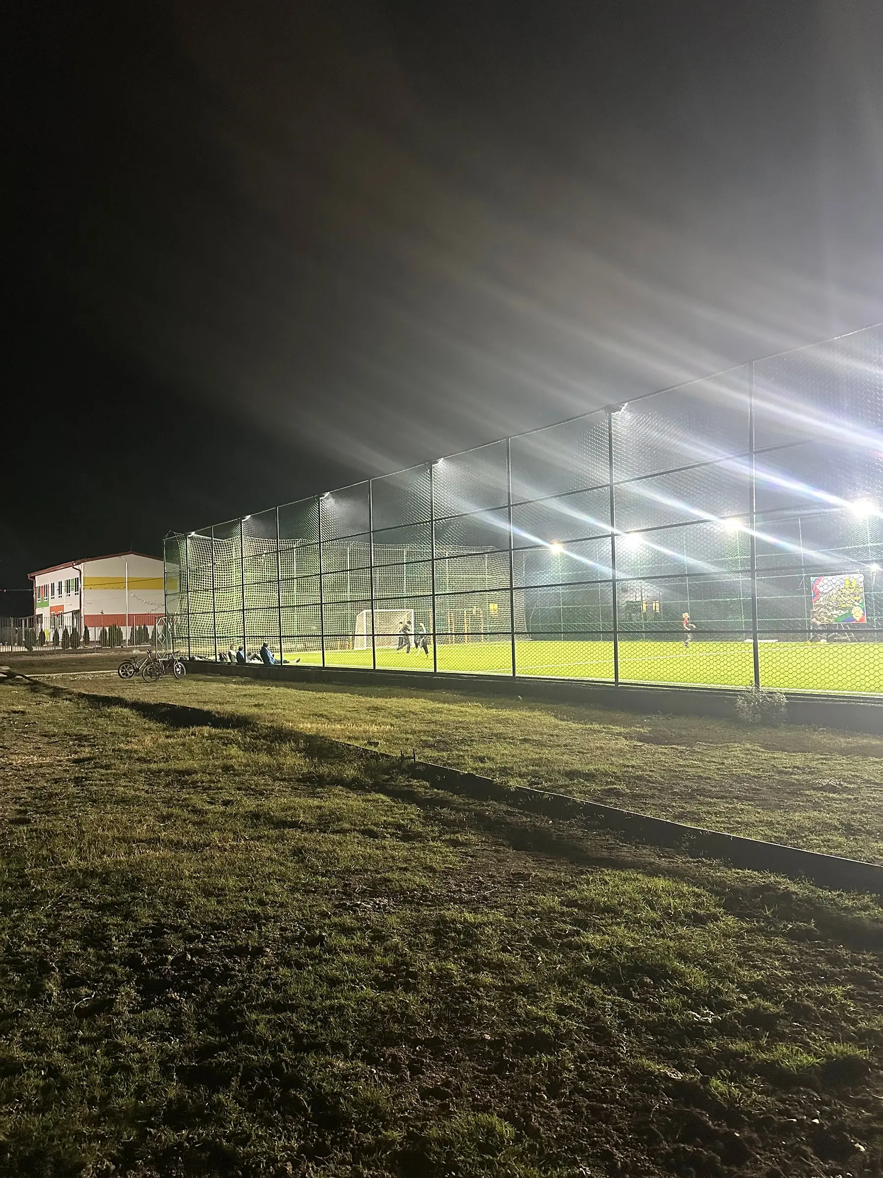 The floodlit football pitch in the evening